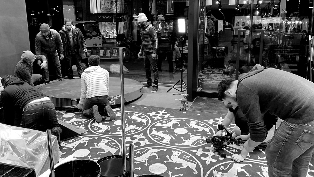 DG_Production_Image_02 Crew assembling a rotating platform inside a boutique window.