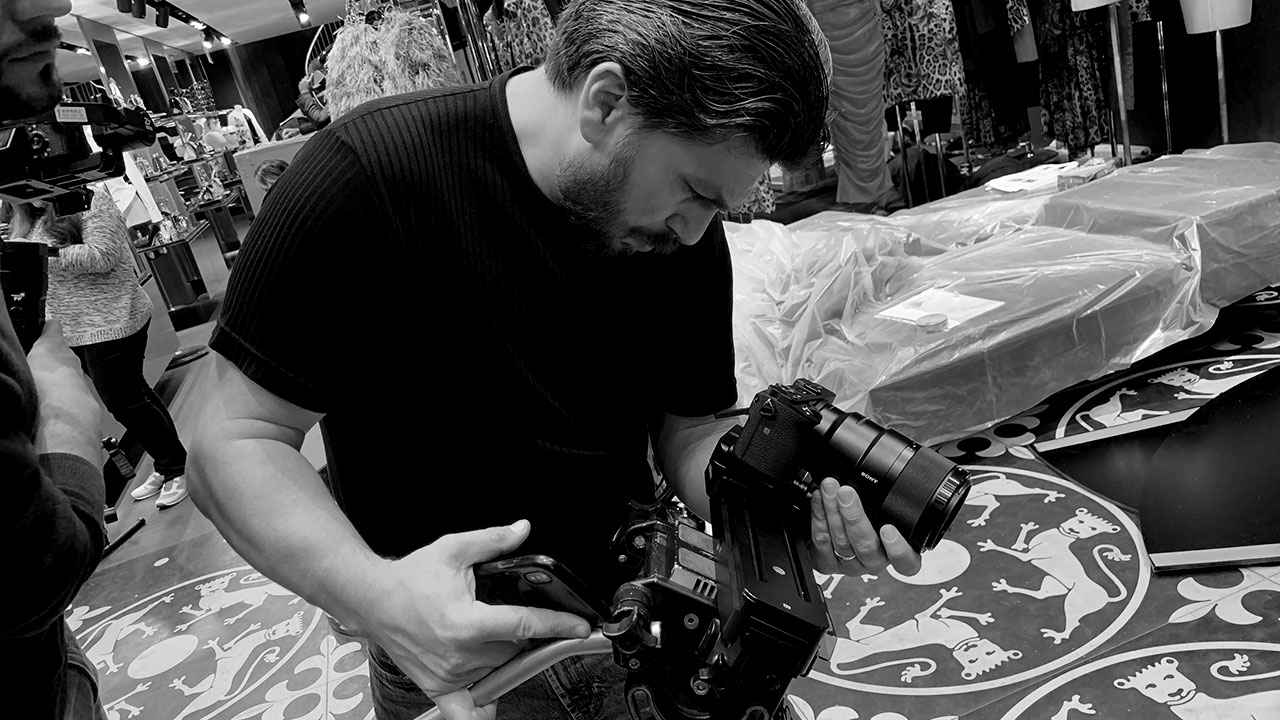 DG_Production_Image_03 Cinematographer reviewing footage on a handheld camera rig.