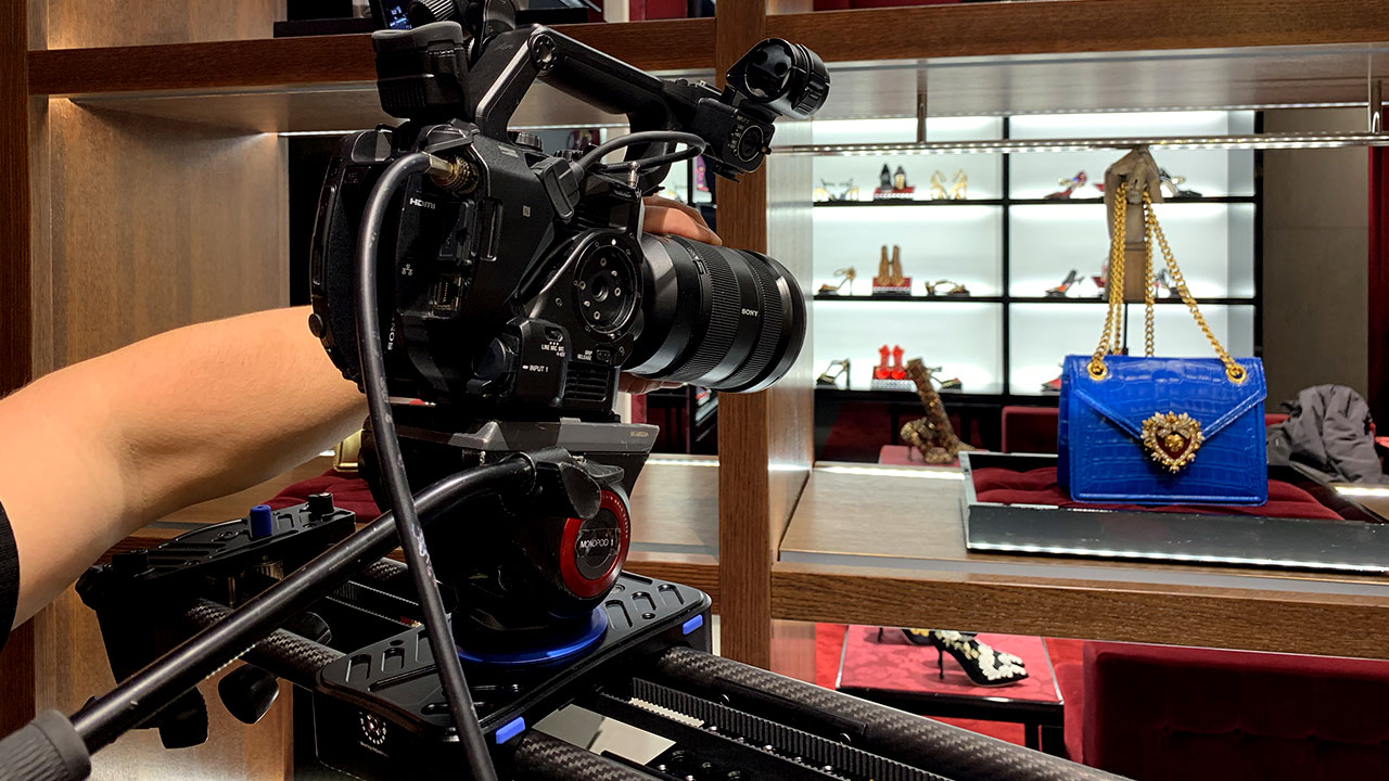 DG_Production_Image_06 A fully rigged camera aimed at a luxury handbag in a boutique.